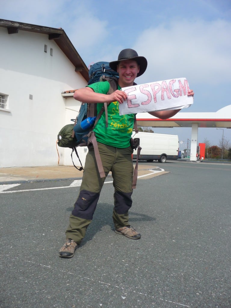 young will holding up a hitchhiking sign