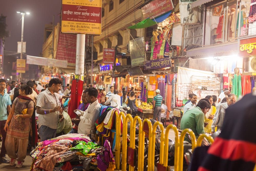 haggling in a colourful bazaar in india while finding travel souvenirs to sell