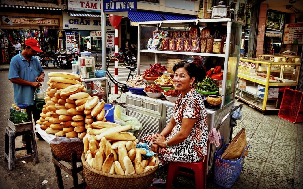 Street food stall in Vietnam selling bread rolls and Banh Mi