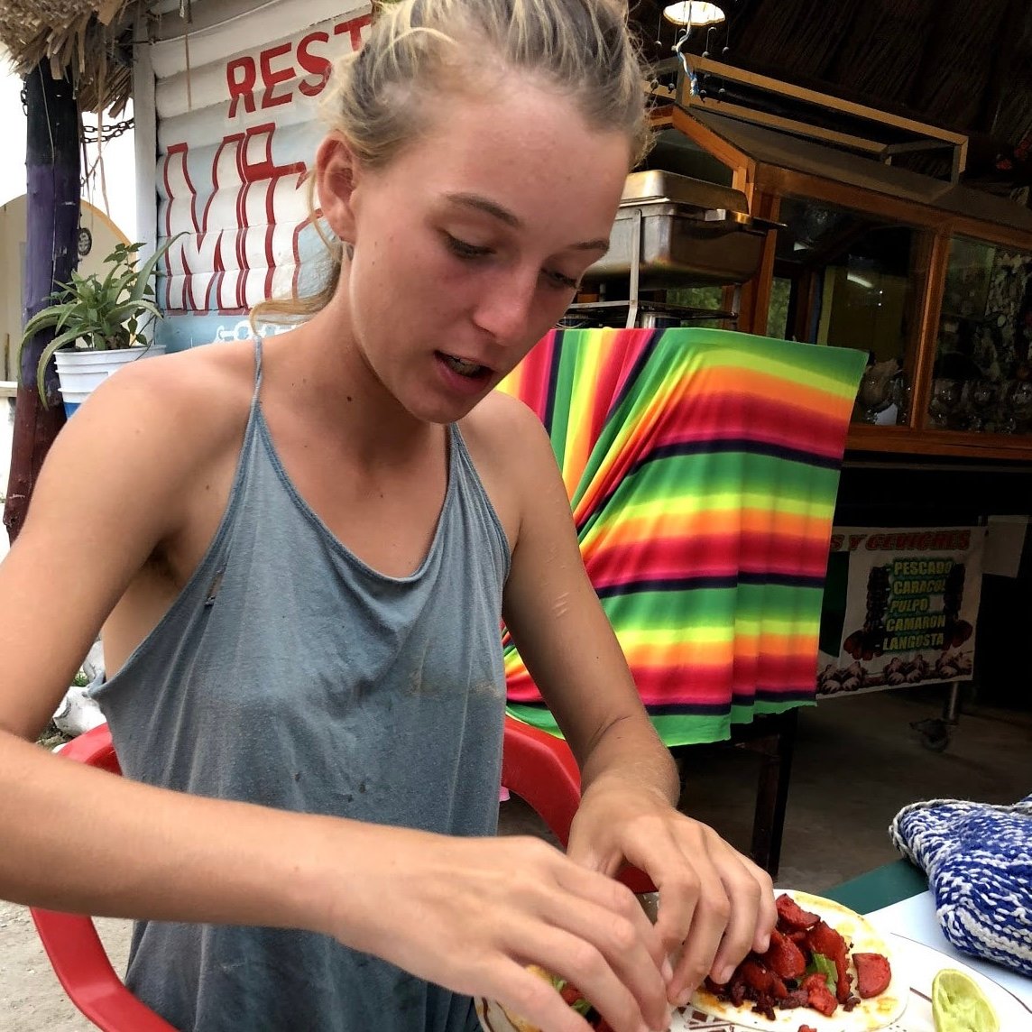 A girl eats tacos while backpacking mexico