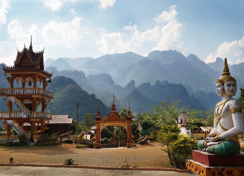 A temple and statue in the mountains while backpacking Laos