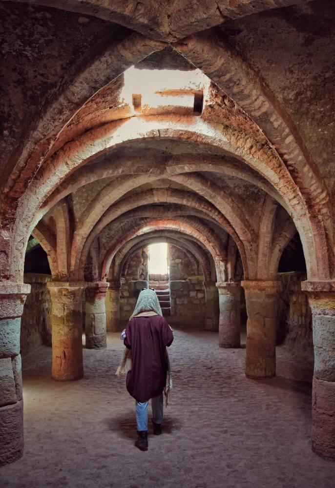 A women walking through hormuz underground chapel
