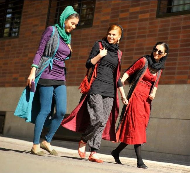 iranian women walking down a street in a group of 3