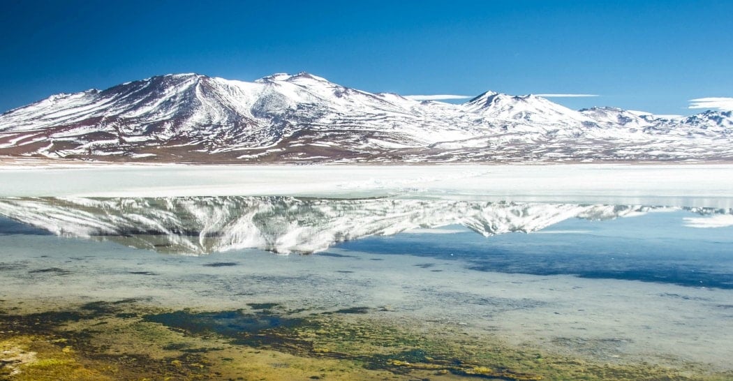 Snow covered mountains and salt flat in Bolivia. 