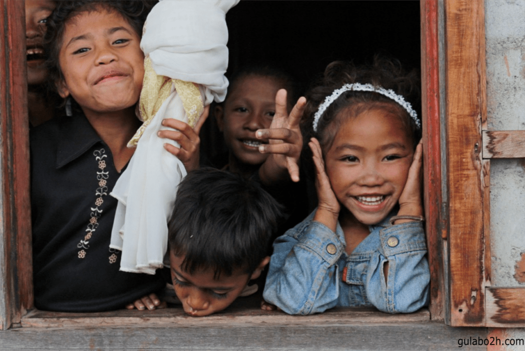 Some local children posing for a photo in a village in Malaysia