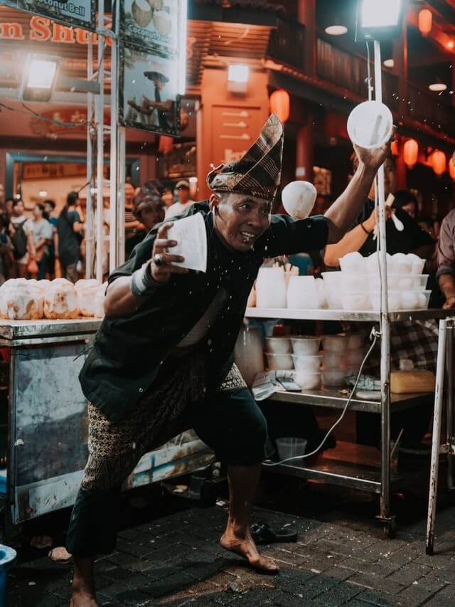 An eccentric Malaysian man running a street food stall in Kuala Lumpur