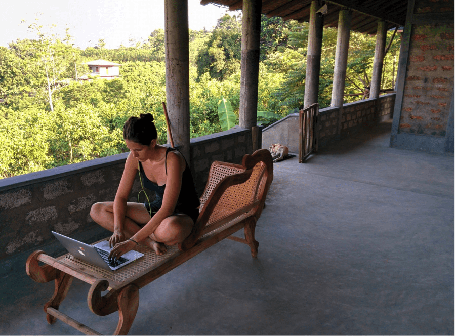 girl sitting on chair working on a laptop