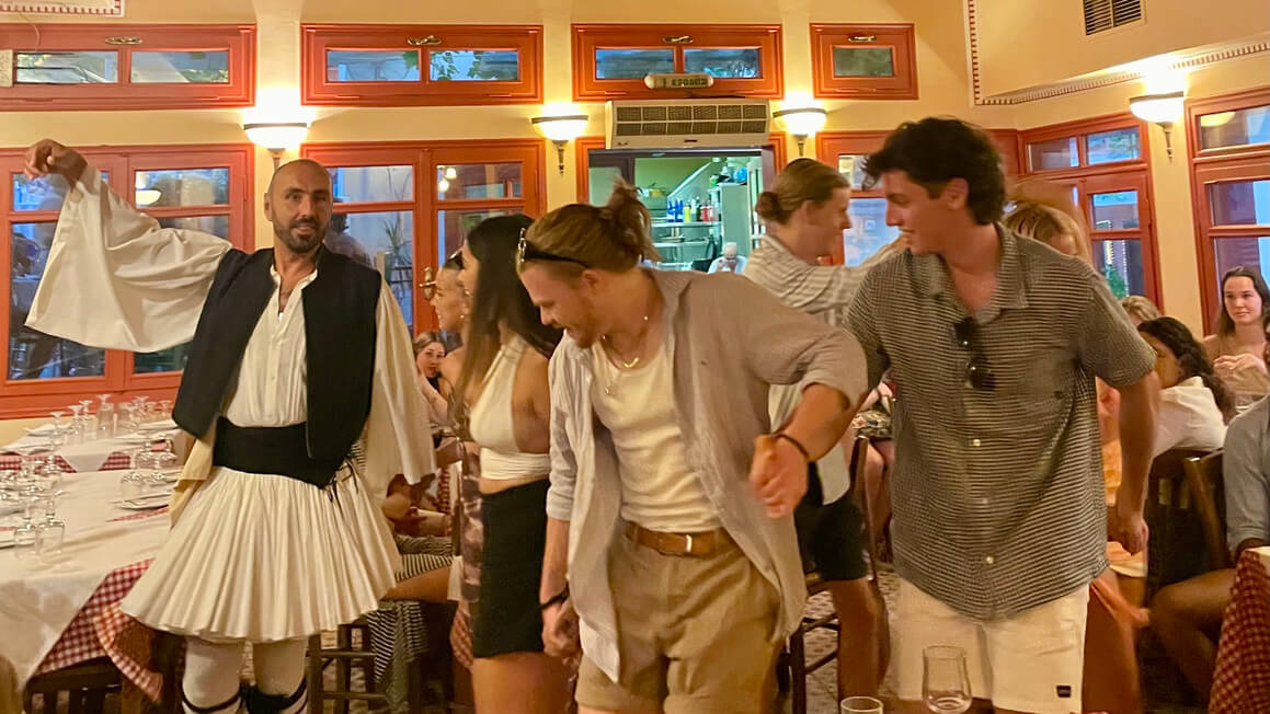 friends dancing in a greek restaurant, athens, greece