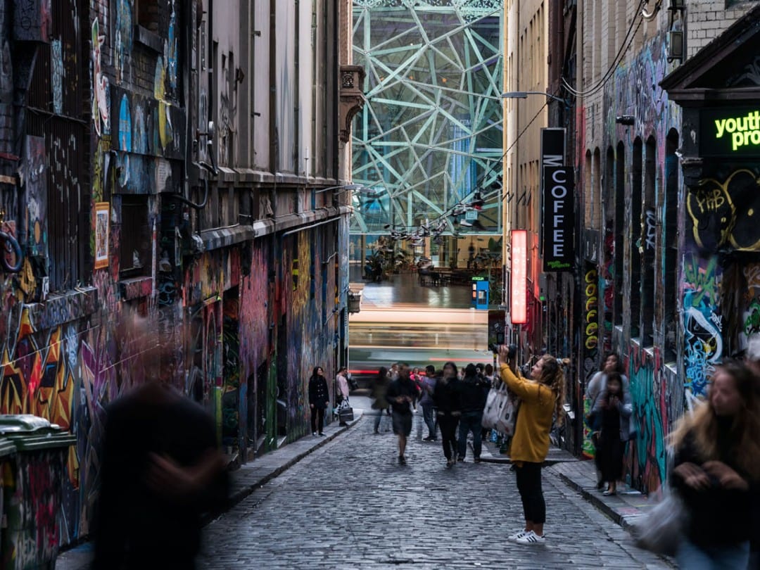 Lady clicking the wall art in Hosier Lane, Melbourne, Australia