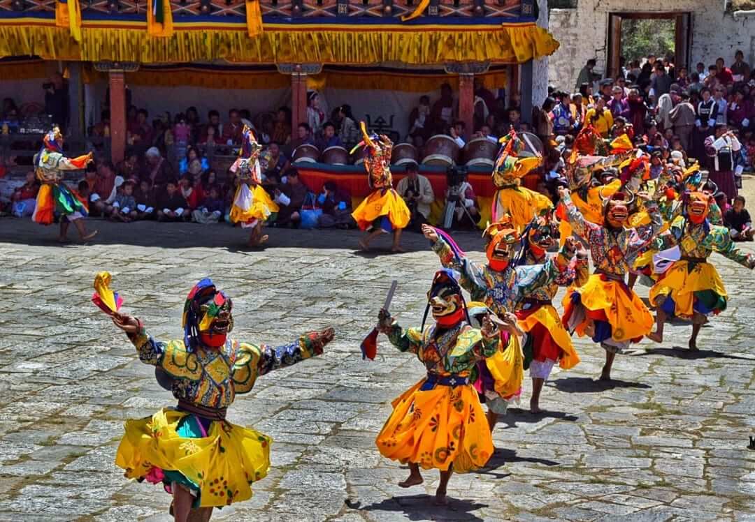 travel to Bhutan monks dancing in paro festival