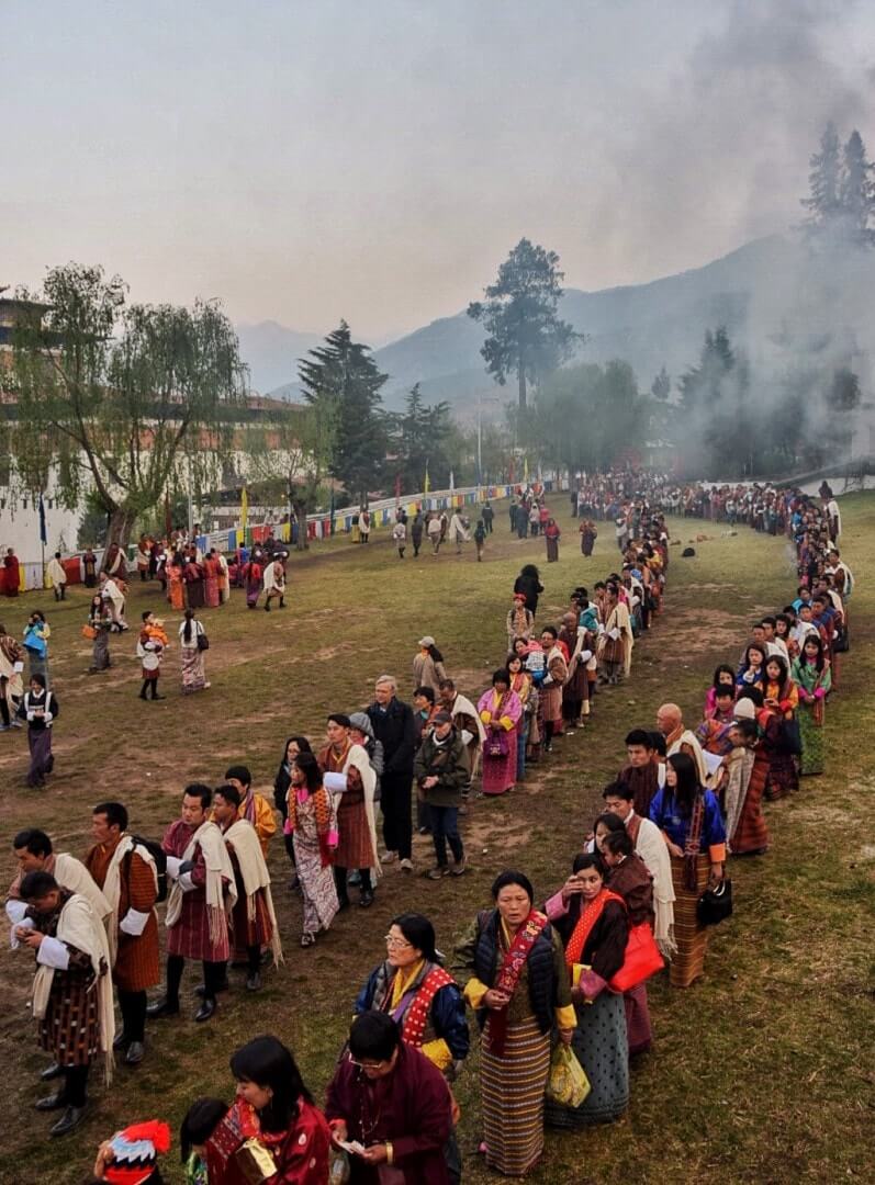 travel to Bhutan people lining up for blessing