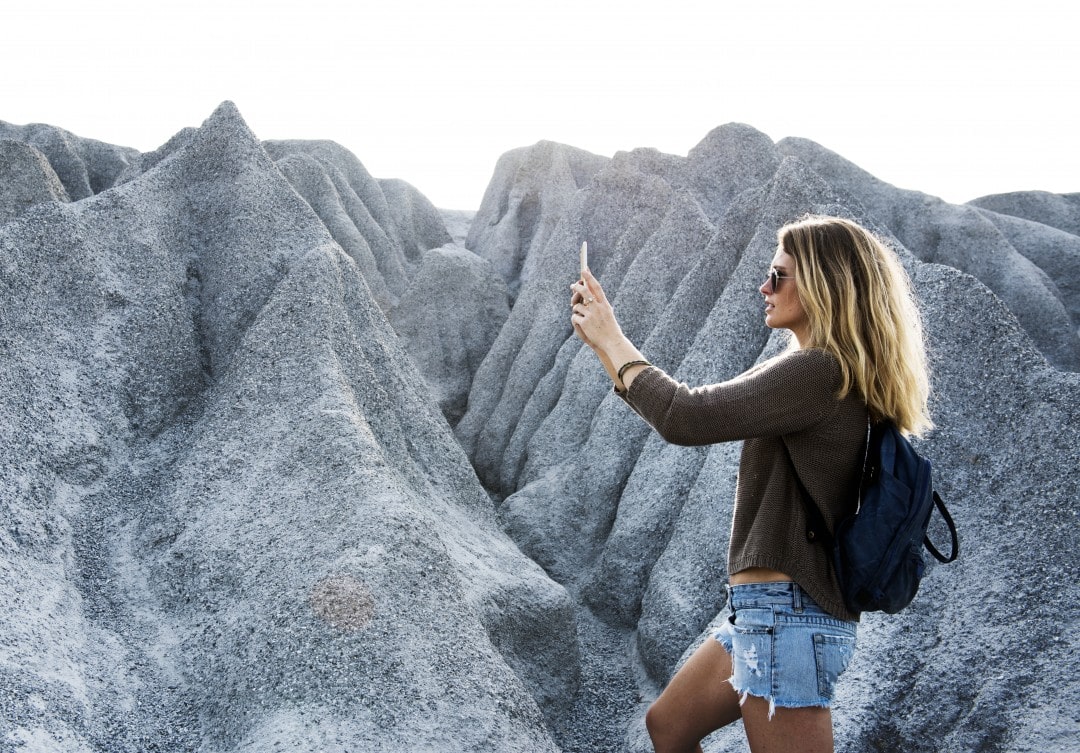 Digital Backups can be done by freelance workers and outdoor enthusiasts Girl taking picture of landscape- importance of photo backup