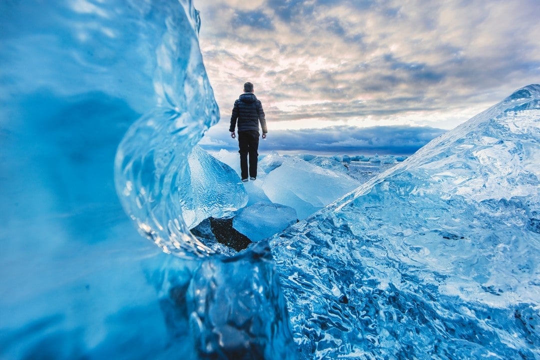 Man enjoying iceberg while travelling Iceland Ring Road