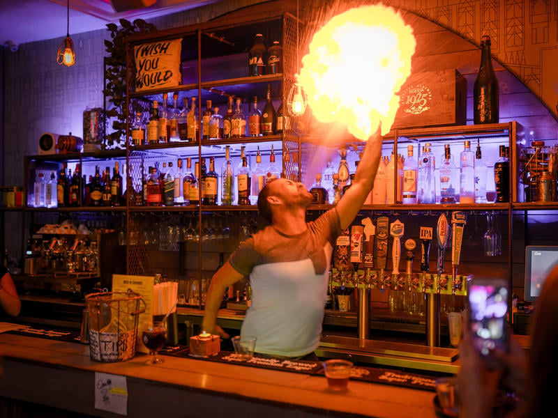 Bartender breathing fire at a cool Europe hostel