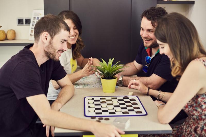 Best Hostel for Couples in Barcelona - Free Hostels Barcelona guests playing chequers.