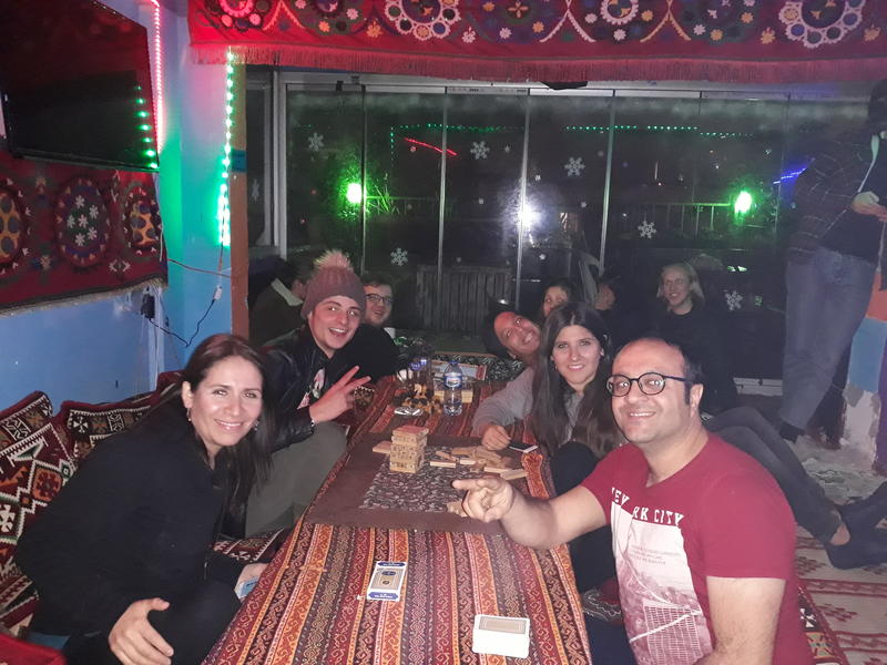 Harmony Hostel best hostels in Istanbul friends sitting around a table playing games smiling for a photo