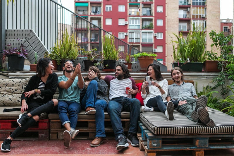 A Cool and Unique Hostel in Barcelona - Pars Tailor’s with guests outside chilling.