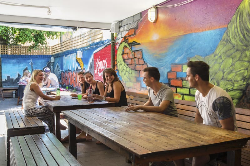 Common area with friends chatting in Summer House Backpackers Sydney - best cheap hostel in Sydney, Australia.