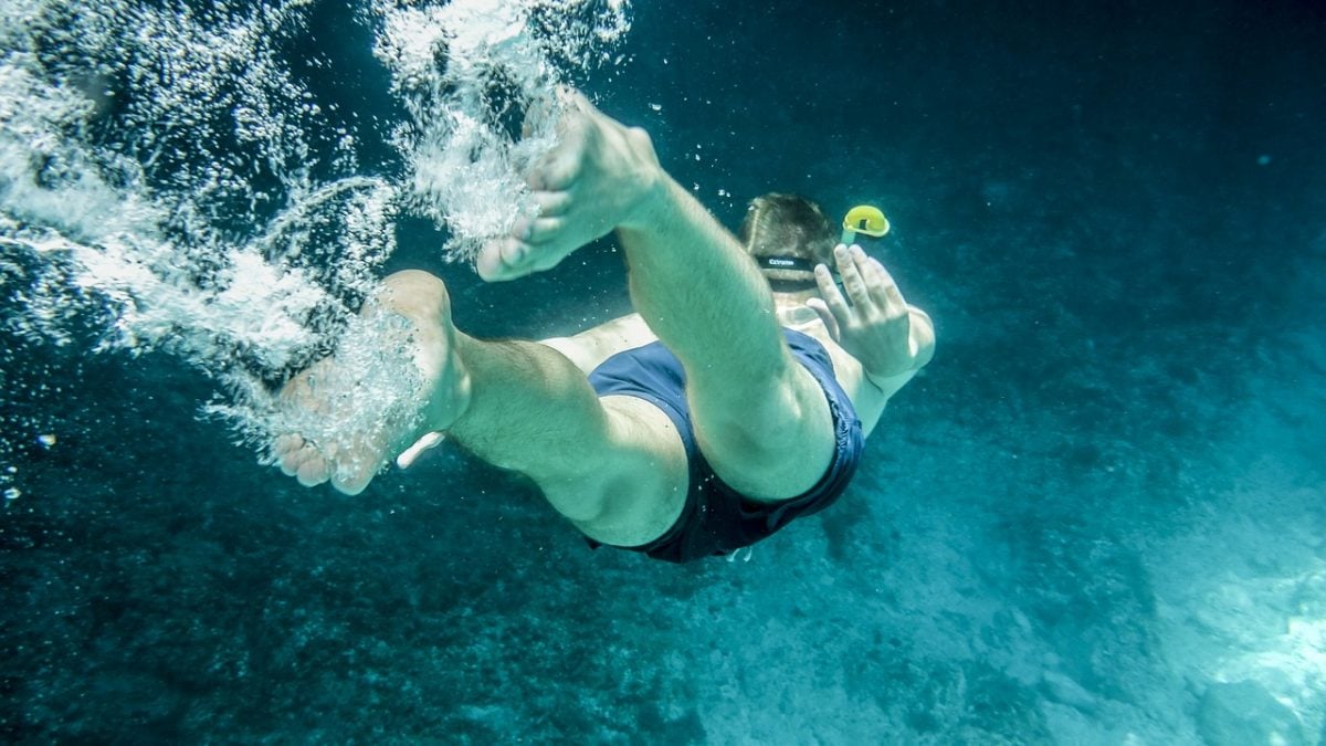 Man snorkelling in Greece at a beautiful dive site - best tourist activity