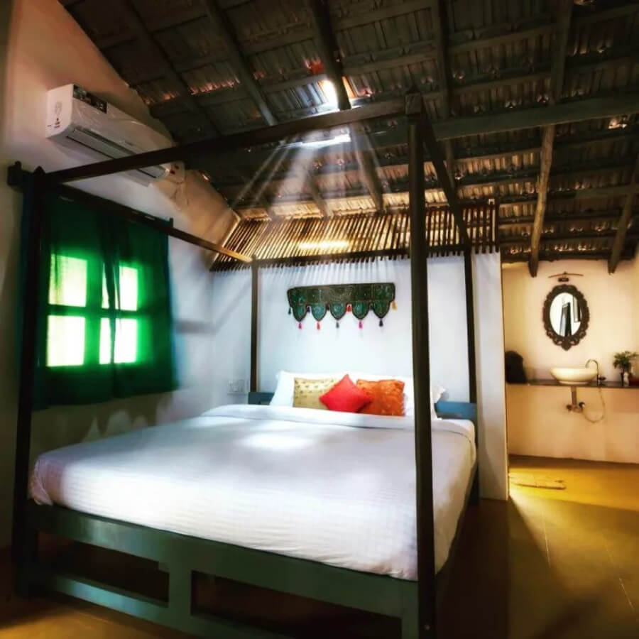 Craft Hostels Double room with thatched roof and natural light onb a clean white bed with ensuite provate bathroom