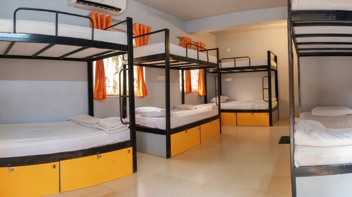 House of Memories dorm room with bunk beds and a window letting in natural light