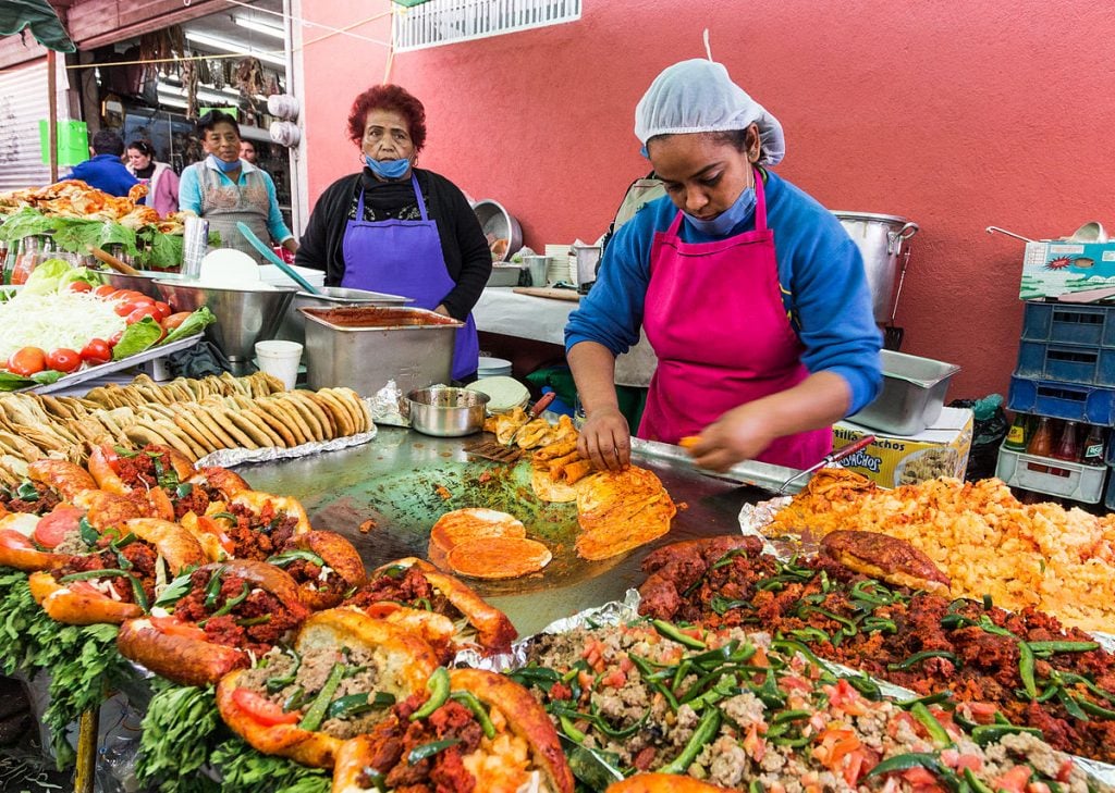 how to eat street food safely women serving up traditional mexican eats on the road