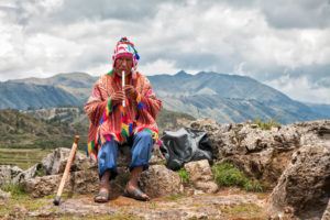 A local man playing the panpies for his English teacher in Peru