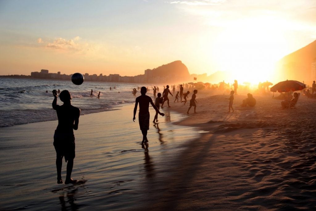 Brazilians playing on Copacabana Beach at Sunset Brazil