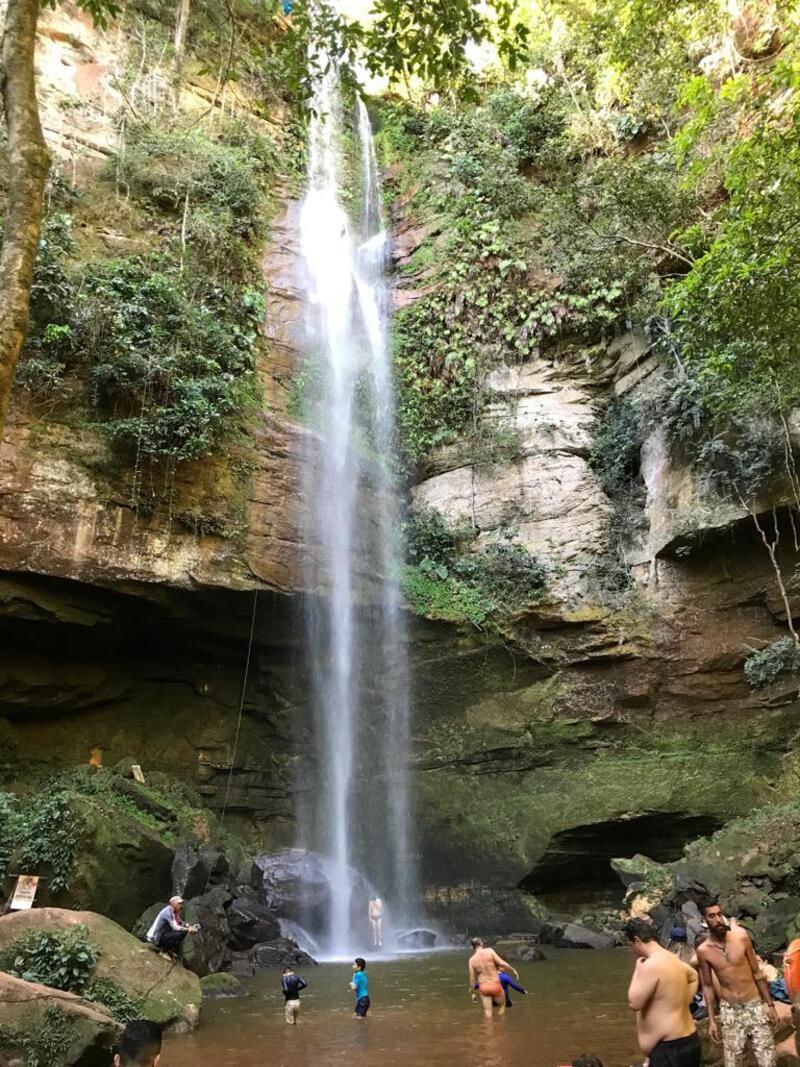 People showering in a big waterfall in the jungle in Brazil. 