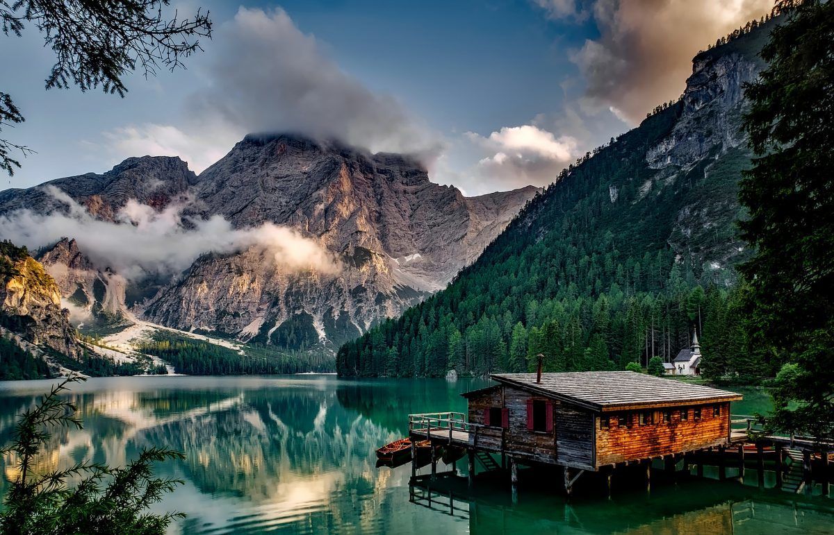alpine lake and cabin in the dolomites of italy