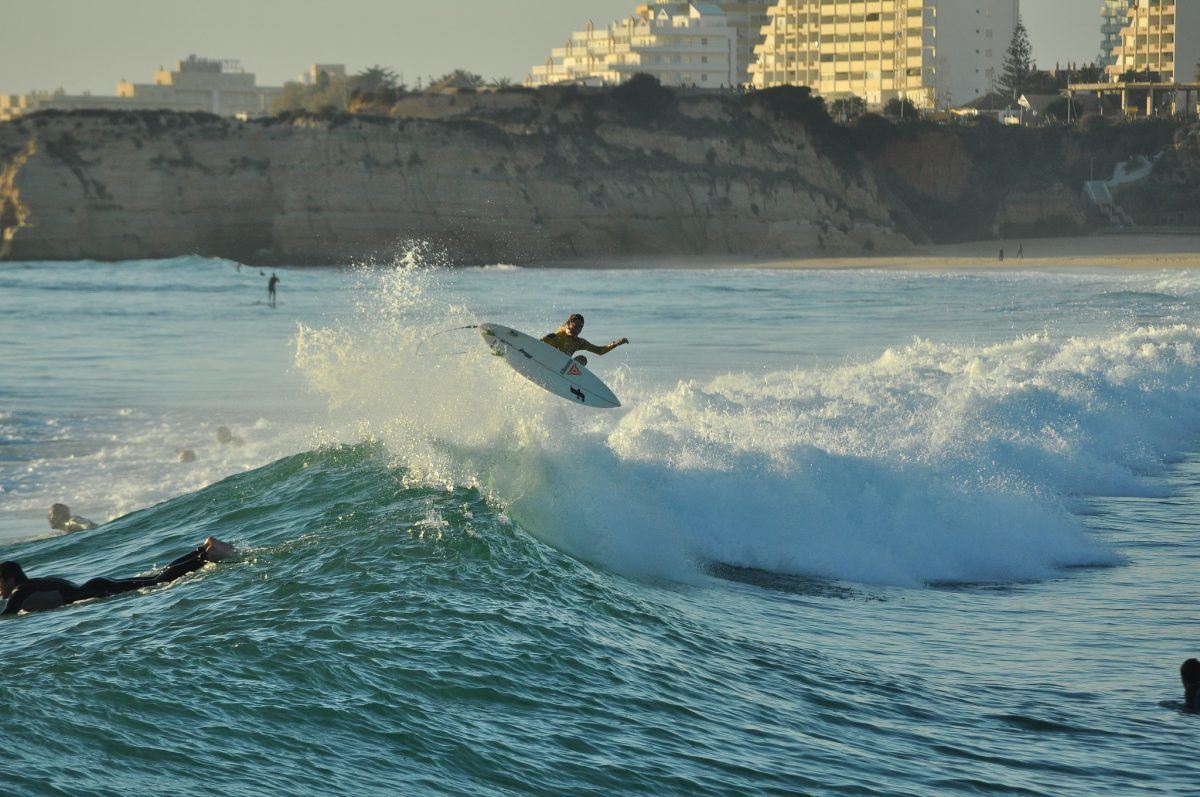 Surfer catching a awave in the algarve portugal