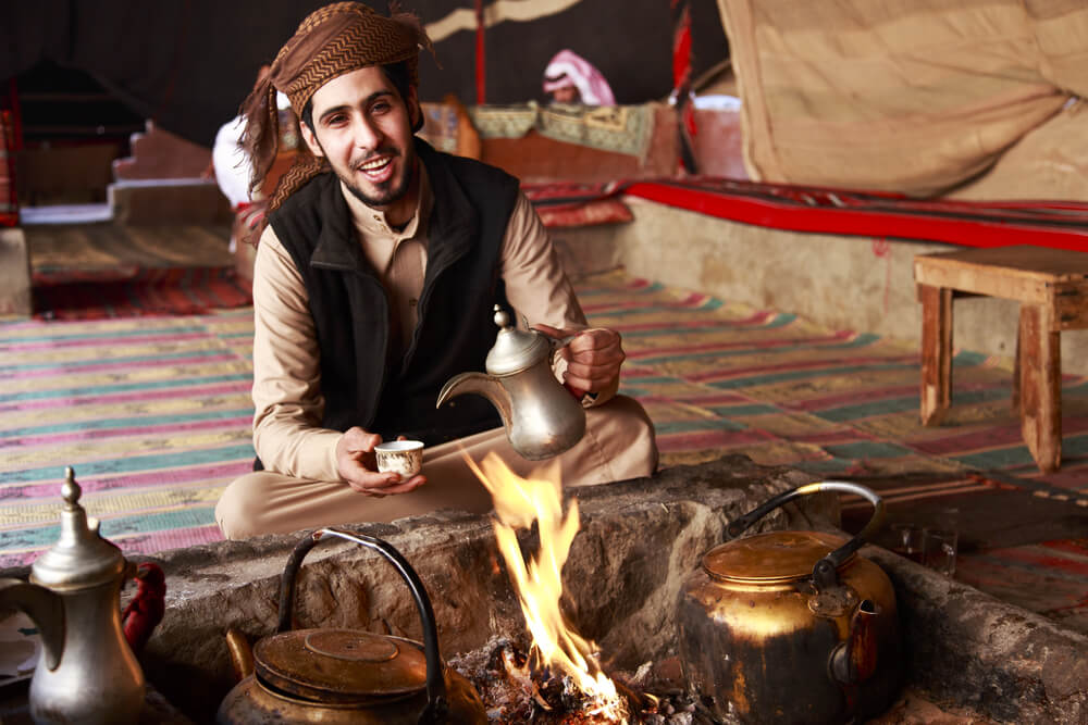 Bedouin man serving coffee to a Jordan backpacker