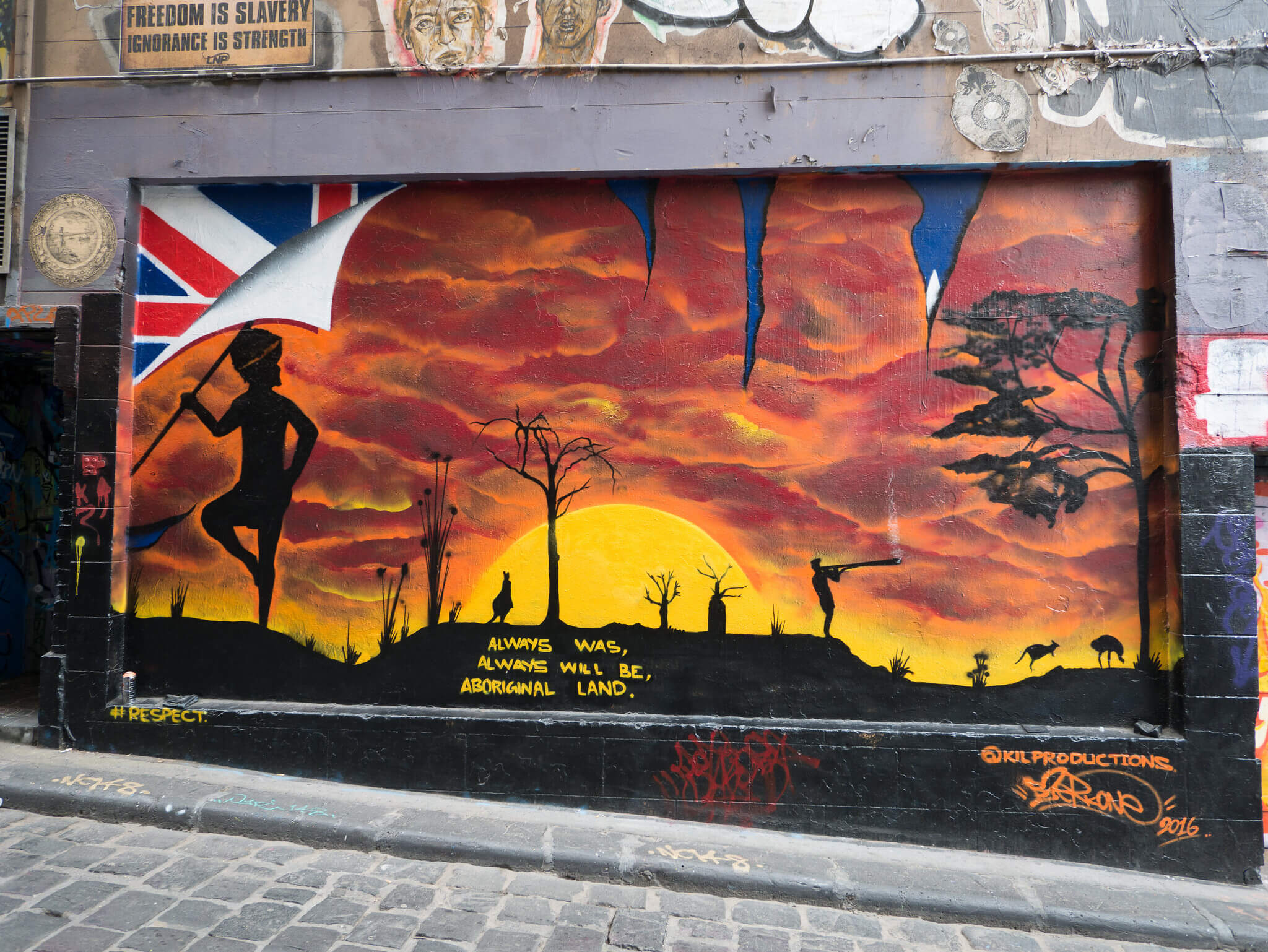 A mural of a sunset with the Aboriginal Rights slogan: Always Was, Always will be Aboriginal Land. 