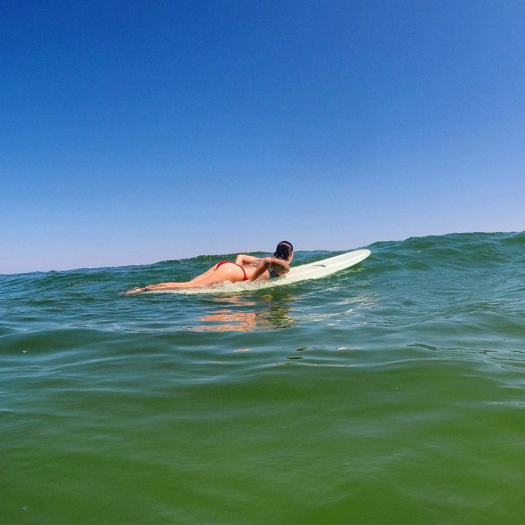 A woman surfing in the ocean off the coast of Australia