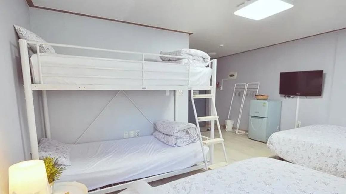 Bunkbeds in white room at Myeongdong Rooftop Hostel