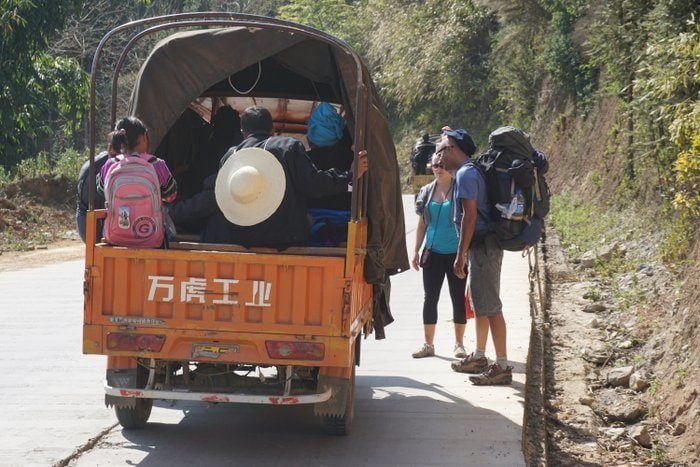 Two backpackers hitchhiking in Cambodia