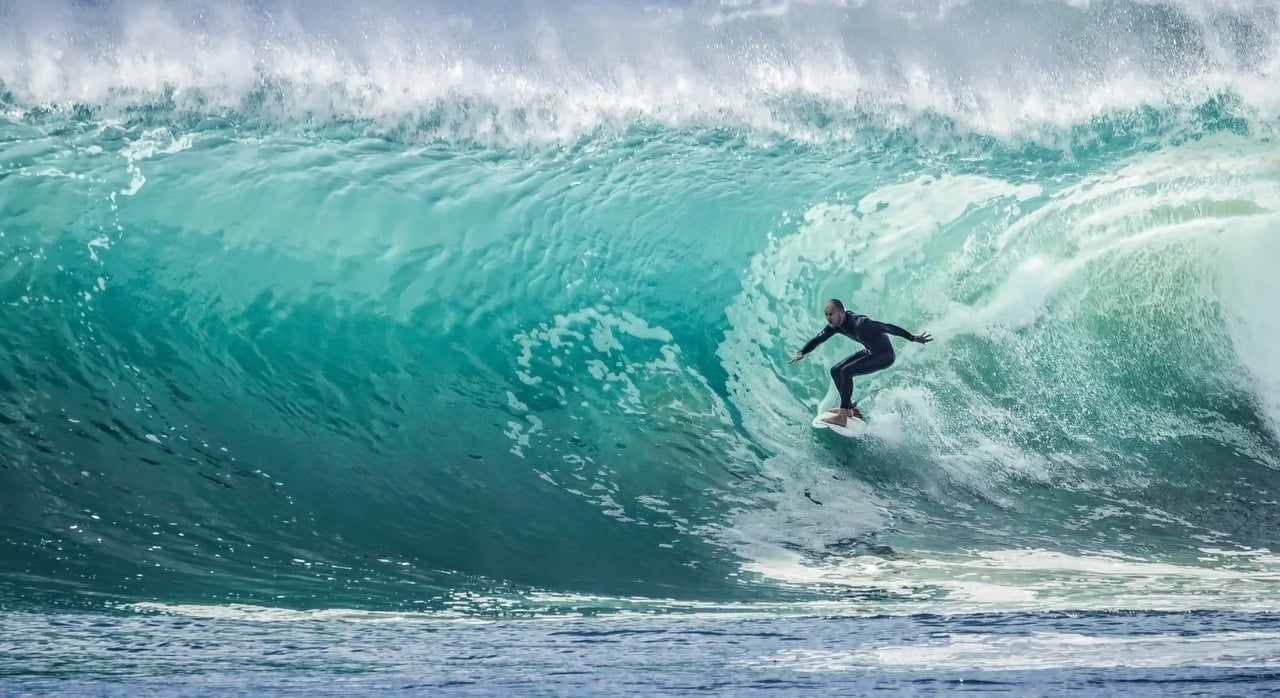 surfer hitting a barrel