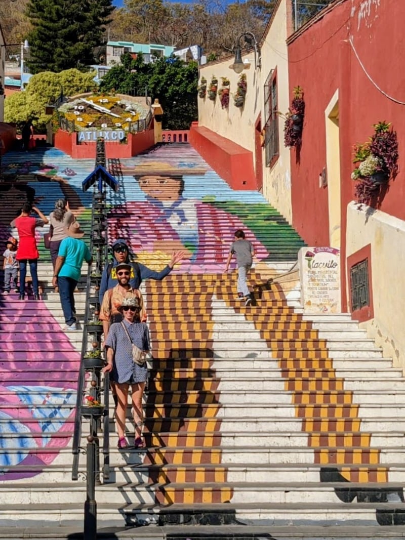 Colourful stairs with people walking and taking pictures in Mexico.