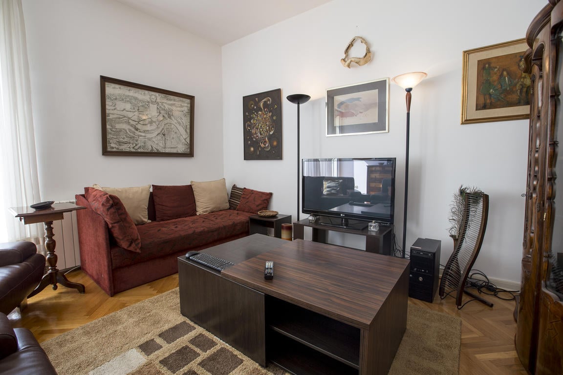 Sun Hostel Belgrade best hostels in Belgrade. clean communal area with a TV and couch and traditional decor