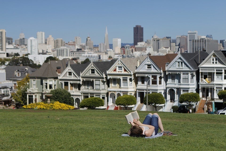 san francisco skyline and girl reading