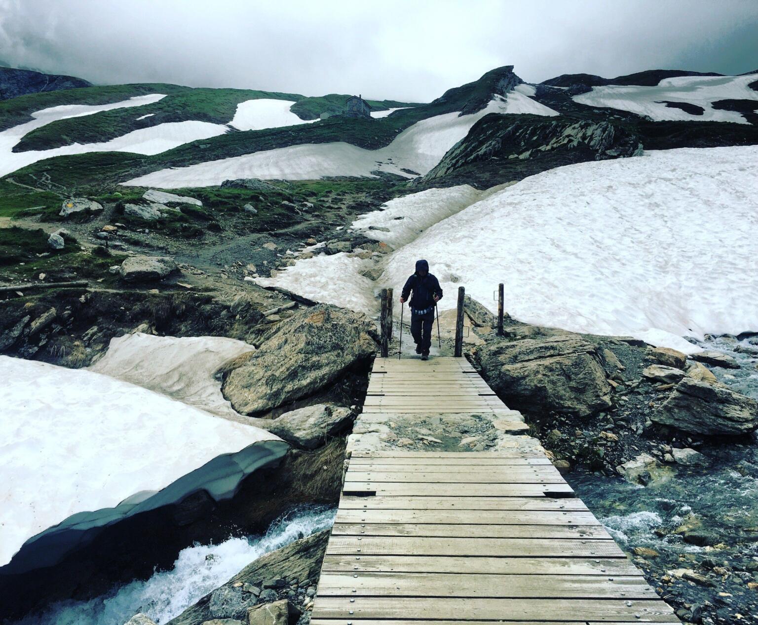 hiking in the snow around a bridge