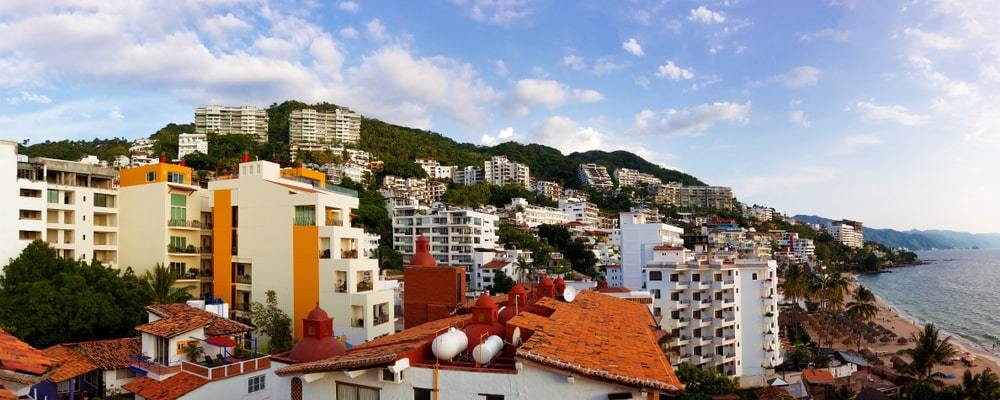 View looking over the Romantic Zone. Many white and orange coloured buildings on the hill. 