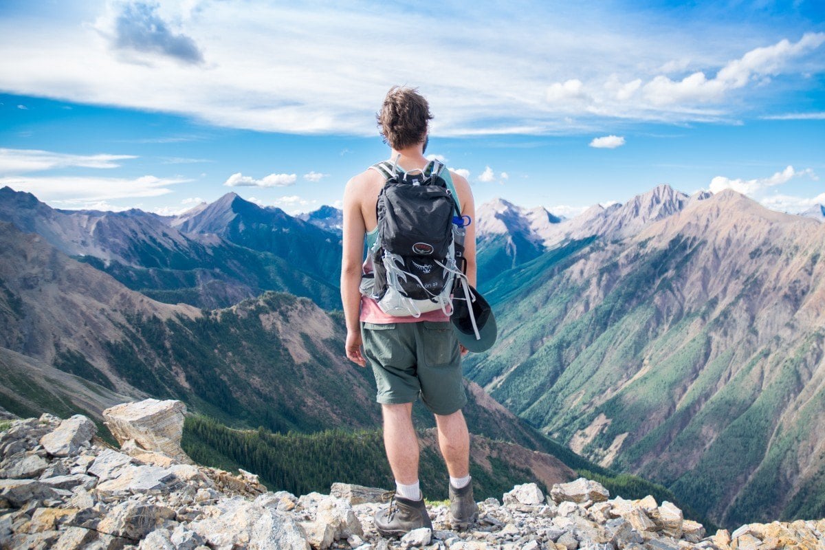 A man in the mountains with his best daypack for hiking