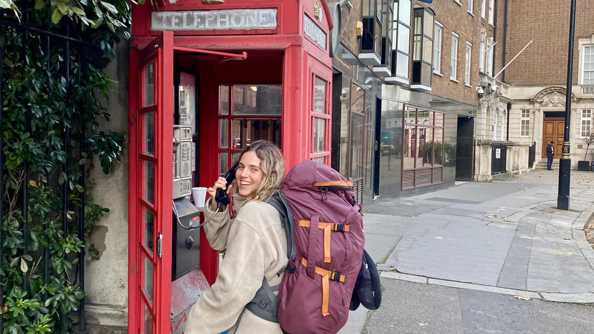 danielle on the phone at a British red phone box 