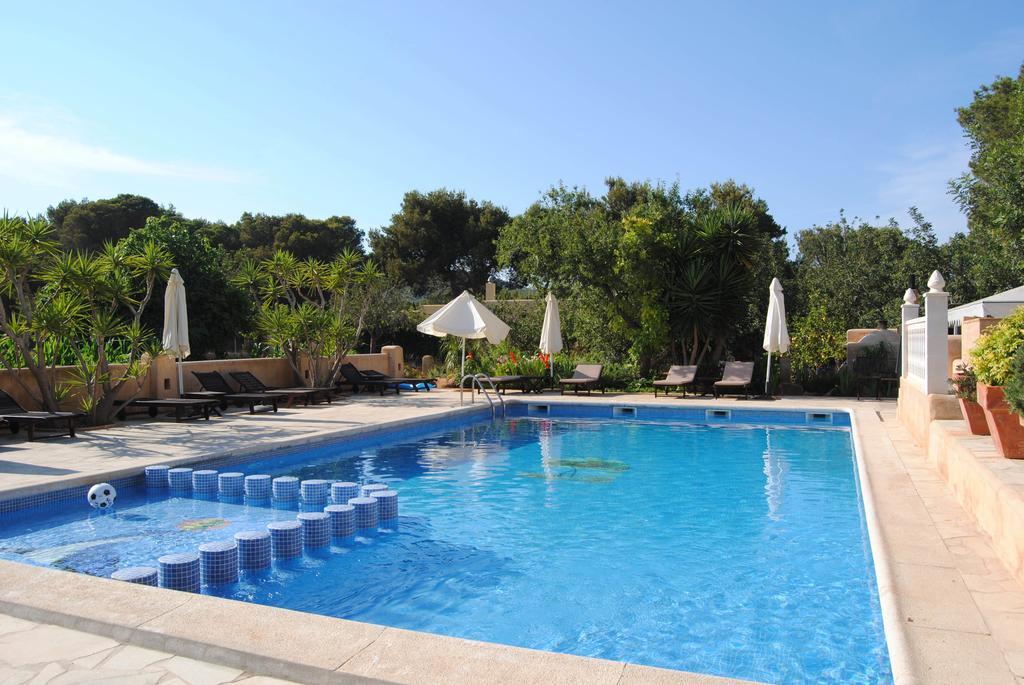 Hostal Restaurante Pou des Lleó best budget hotels in Ibiza. Pool outside in the sunshine with lush garden around the outdoor pool.