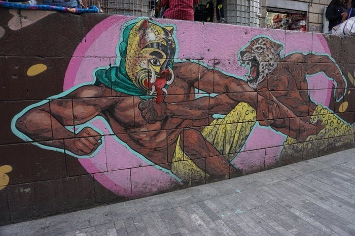 Mexico Street Art Lucho Libre fighters with animal masks on a street wall