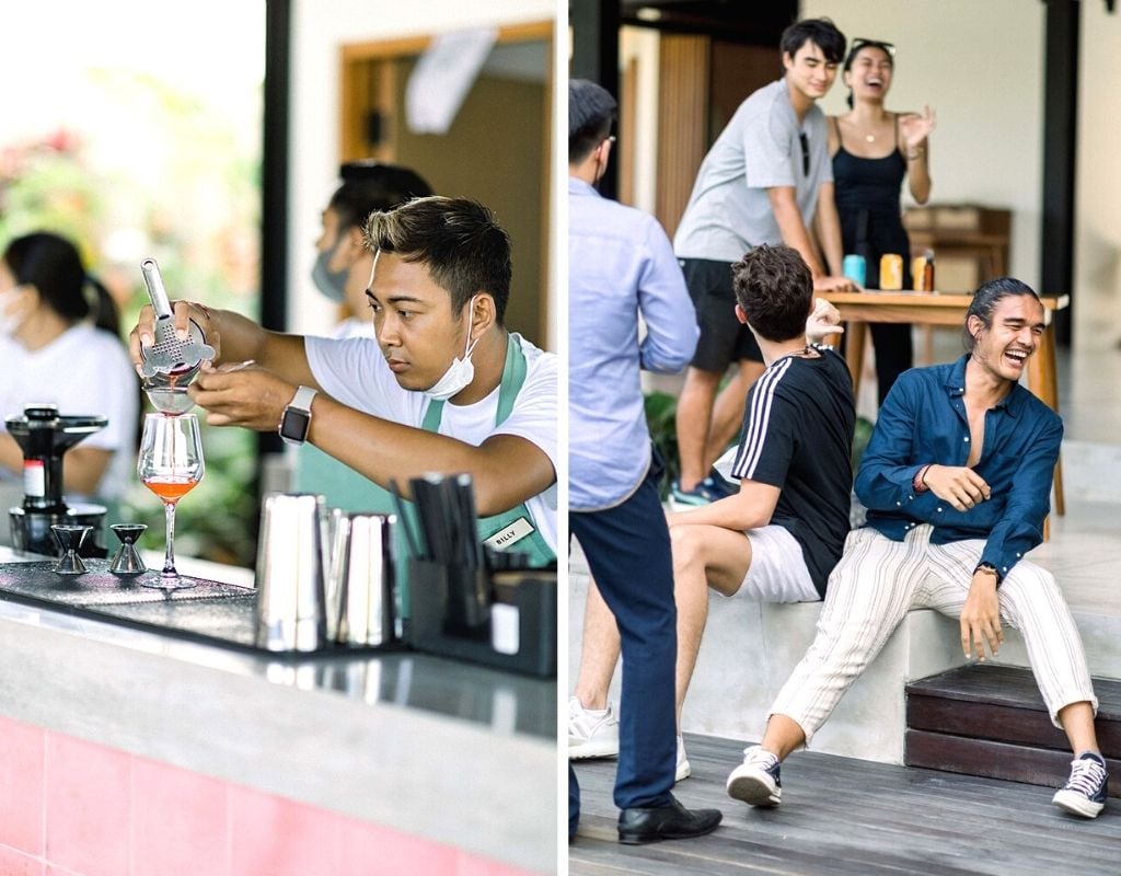 bartender making a drink and guests laughing at tribal hostel