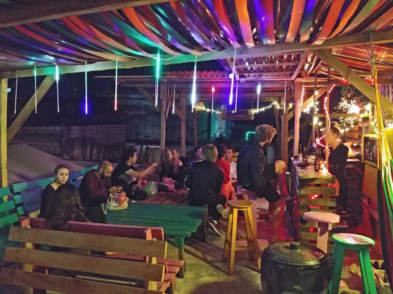 Iguana Hostel best hostels in Oaxaca with people at the bar with lights