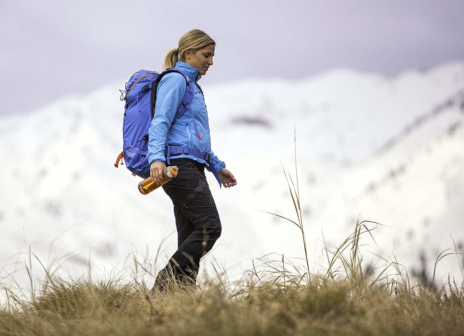 A woman hiking with a medium size backpack