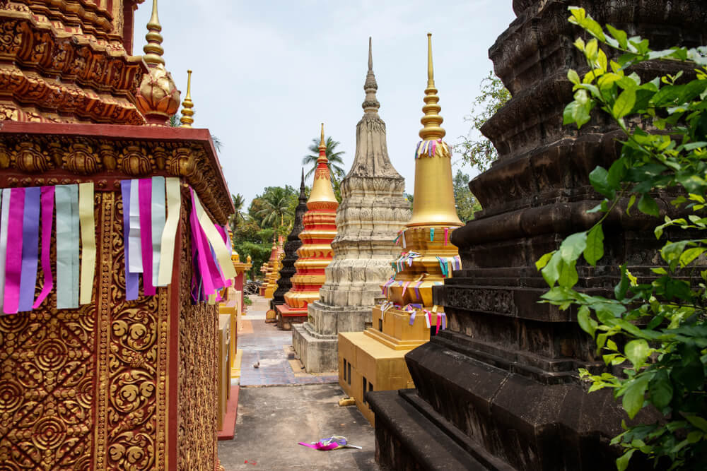 colorful cambodian gravestones in stone and gold in a cemetary in siem reap